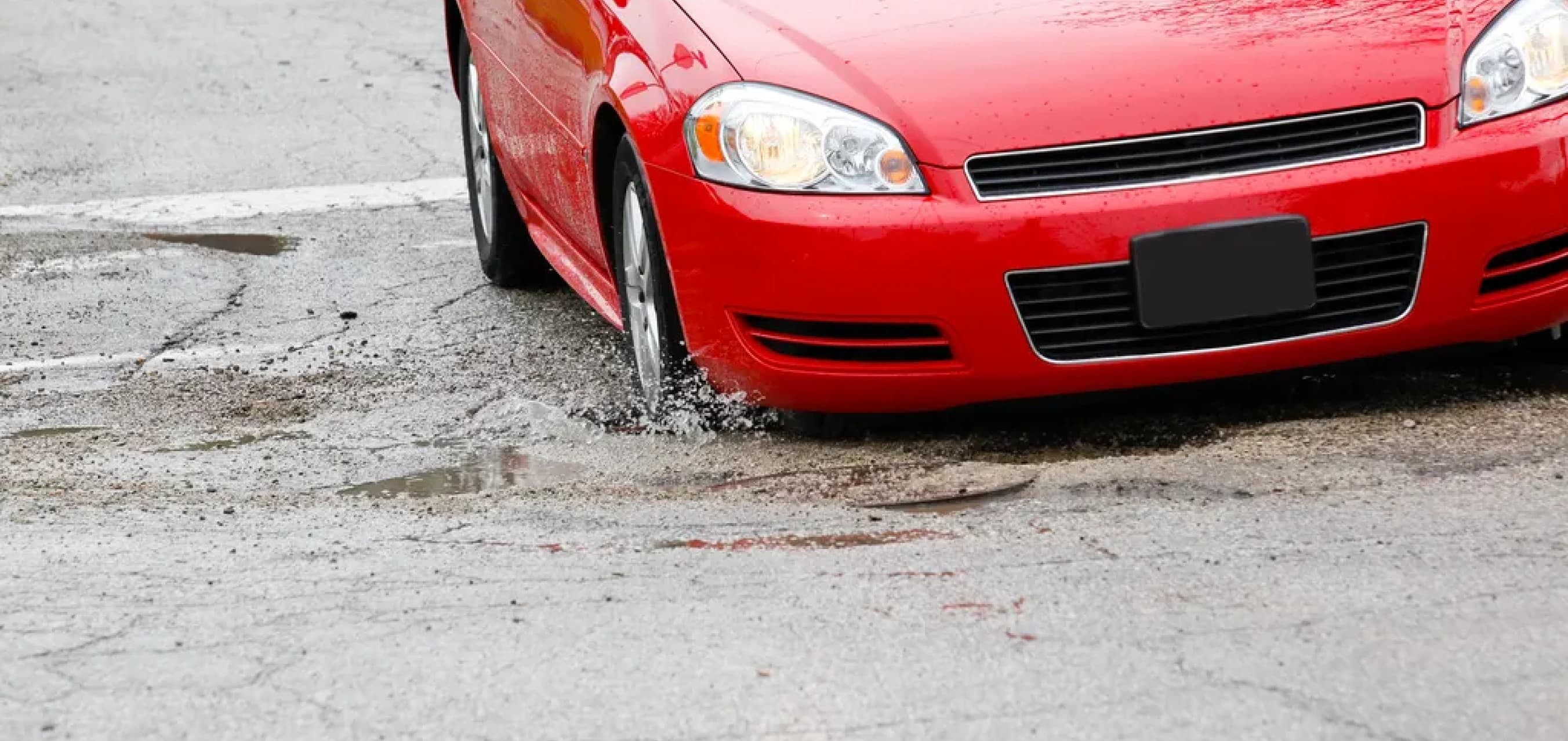 Car hitting a pothole